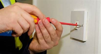 A modern white switch plate being fitted with cables neatly tucked away.